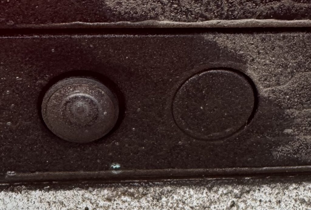 Picture of rear view camera from Polestar, which has just been washed by a liquid spray